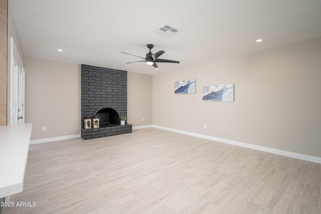 4506 W Golden Ln, Glendale, AZ 85302 - unfurnished living room featuring recessed lighting, ceiling fan, a brick fireplace, baseboards, and visible vents