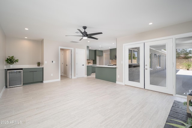 4506 W Golden Ln, Glendale, AZ 85302 - unfurnished living room with french doors, recessed lighting, light wood finished floors, and baseboards