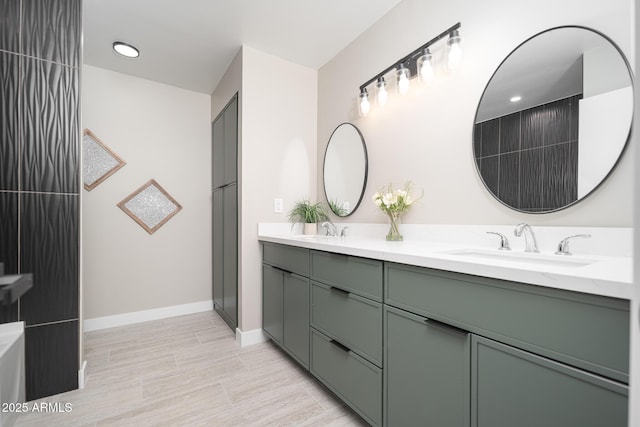 4506 W Golden Ln, Glendale, AZ 85302 - bathroom featuring double vanity, baseboards, and a sink