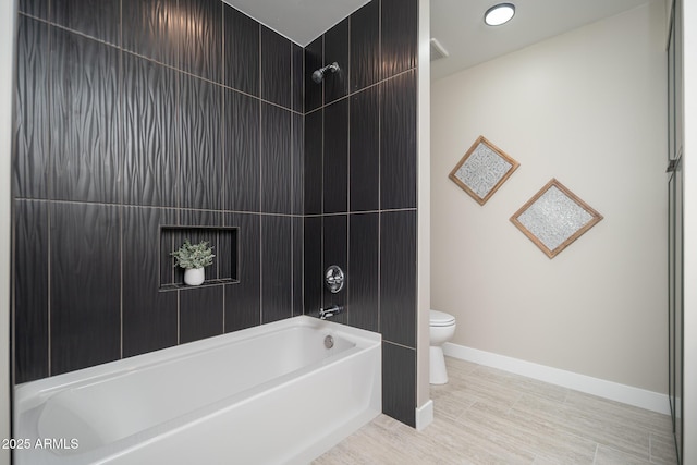 4506 W Golden Ln, Glendale, AZ 85302 - bathroom featuring baseboards, toilet, and shower / bathtub combination