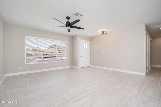 4506 W Golden Ln, Glendale, AZ 85302 - unfurnished living room featuring attic access, light wood-style floors, a ceiling fan, visible vents, and baseboards