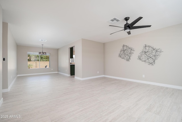 4506 W Golden Ln, Glendale, AZ 85302 - unfurnished living room with visible vents, baseboards, ceiling fan with notable chandelier, and light wood-style floors