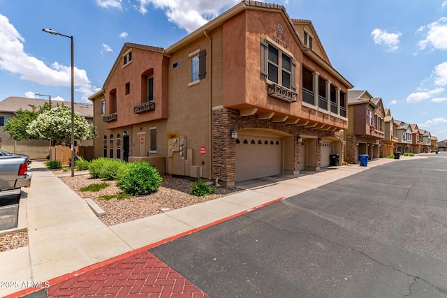 1350 S Greenfield Rd Unit 1123, Mesa, AZ 85206 - view of building exterior with a garage and a residential view