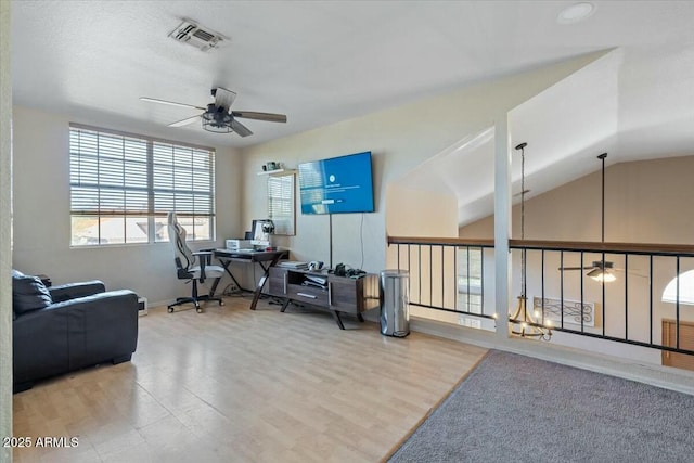 interior space featuring ceiling fan, lofted ceiling, and hardwood / wood-style flooring