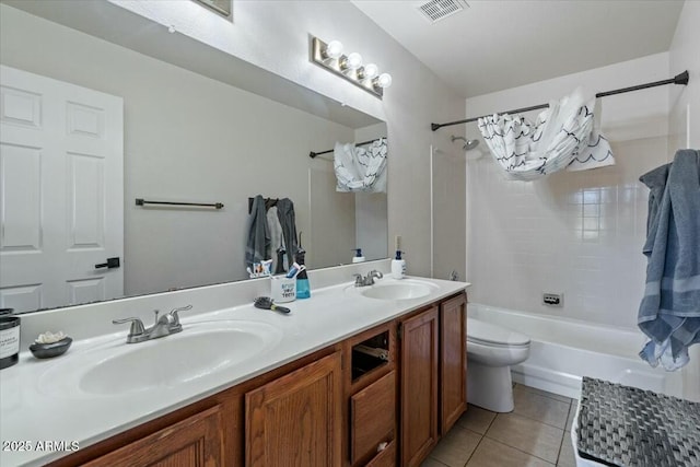 full bathroom featuring tile patterned floors, vanity, toilet, and shower / washtub combination