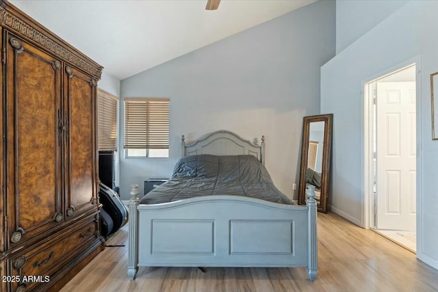 bedroom featuring ceiling fan, light wood-type flooring, and lofted ceiling