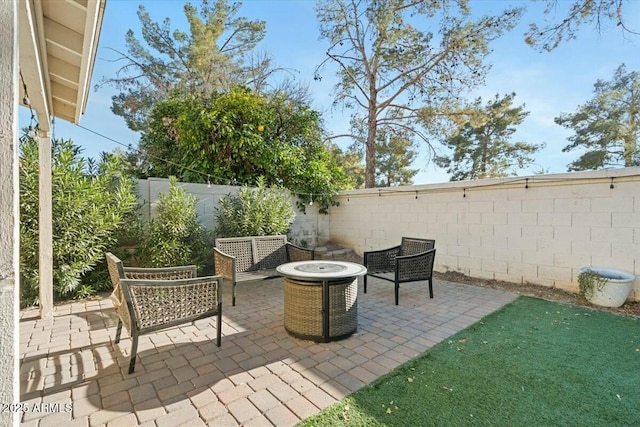 view of patio / terrace featuring an outdoor fire pit