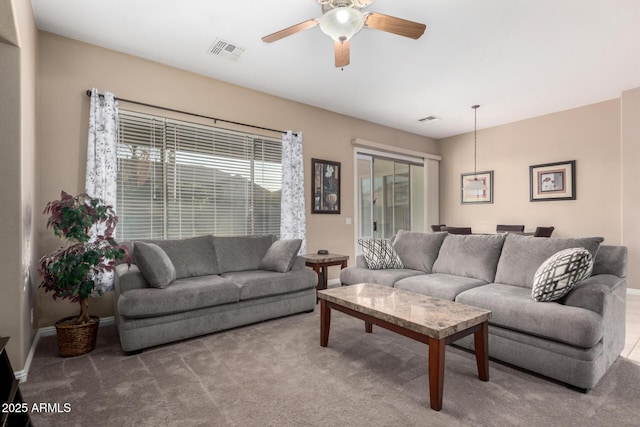 carpeted living room featuring ceiling fan