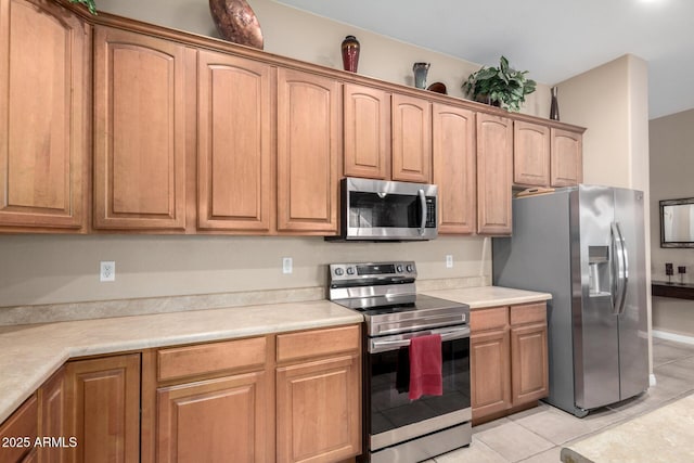 kitchen featuring light tile patterned floors and appliances with stainless steel finishes