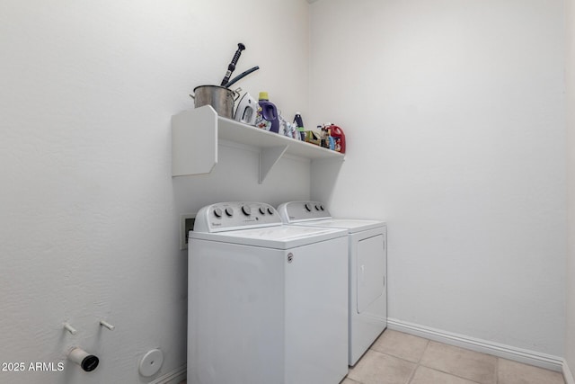 laundry room with light tile patterned floors and washing machine and clothes dryer