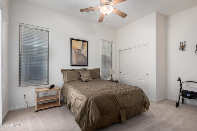 carpeted bedroom featuring a closet and ceiling fan