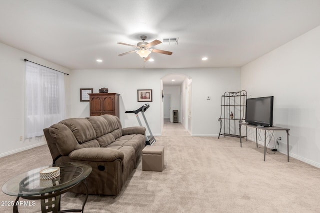 carpeted living room with ceiling fan