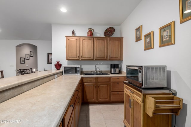 kitchen featuring sink and light tile patterned flooring