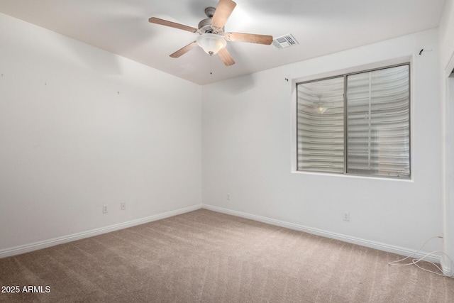 unfurnished room with ceiling fan and light colored carpet