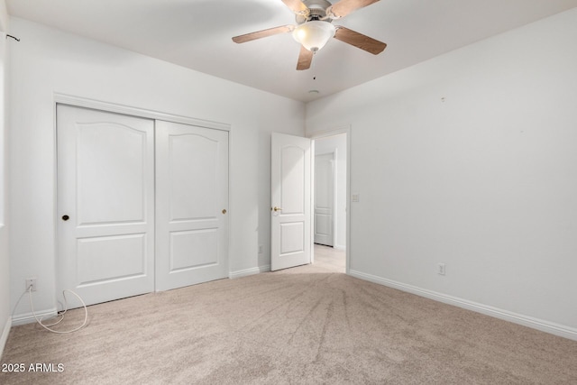 unfurnished bedroom with a closet, ceiling fan, and light carpet