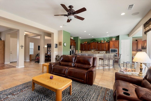 tiled living room featuring ceiling fan