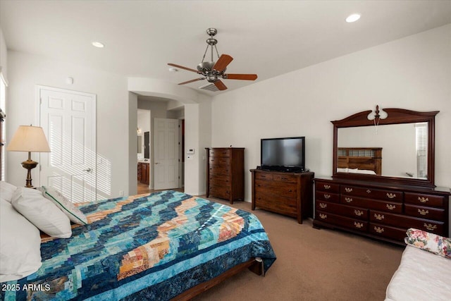 bedroom with carpet flooring, ensuite bathroom, and ceiling fan