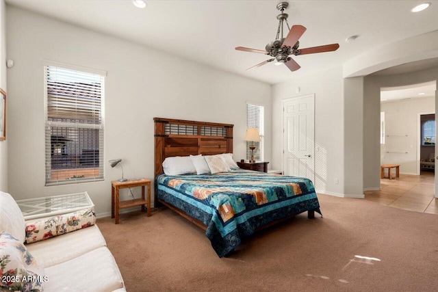 carpeted bedroom with ceiling fan and a closet