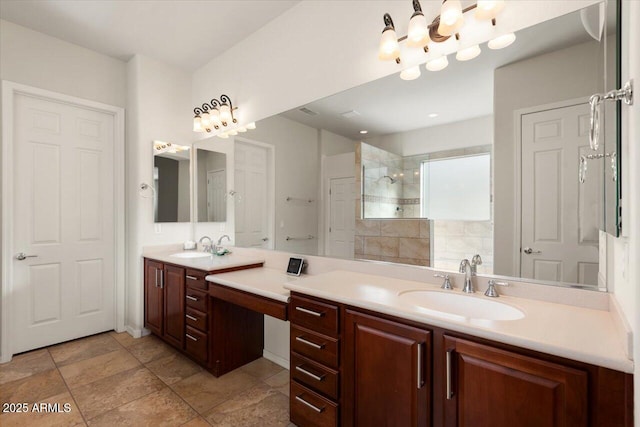 bathroom with vanity and a tile shower