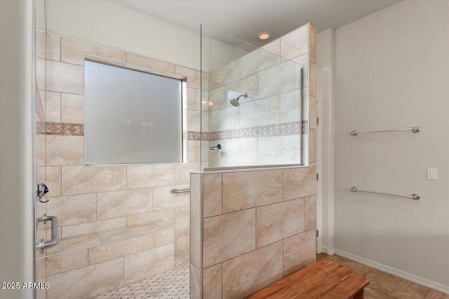 bathroom with a tile shower