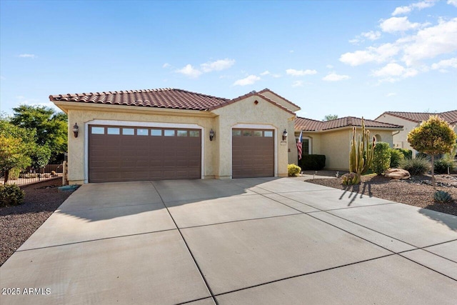 mediterranean / spanish-style home with a garage