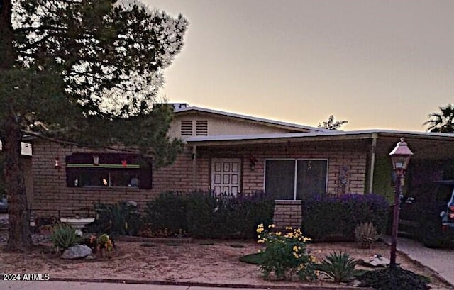 view of back house at dusk