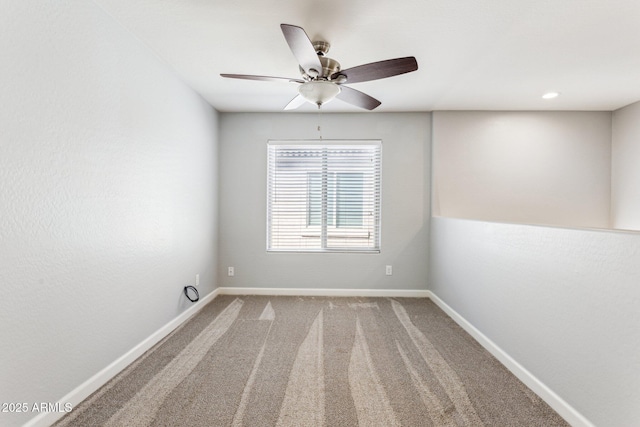 empty room featuring light colored carpet and ceiling fan