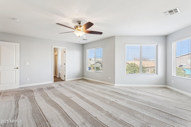 interior space featuring ceiling fan, a healthy amount of sunlight, and light carpet