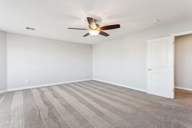 carpeted empty room featuring ceiling fan