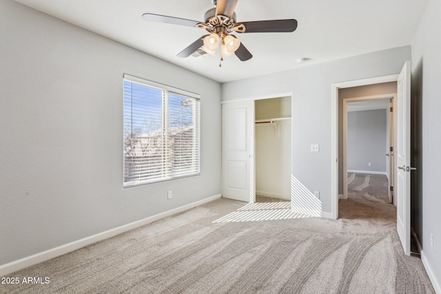 unfurnished bedroom featuring light carpet, a closet, and ceiling fan