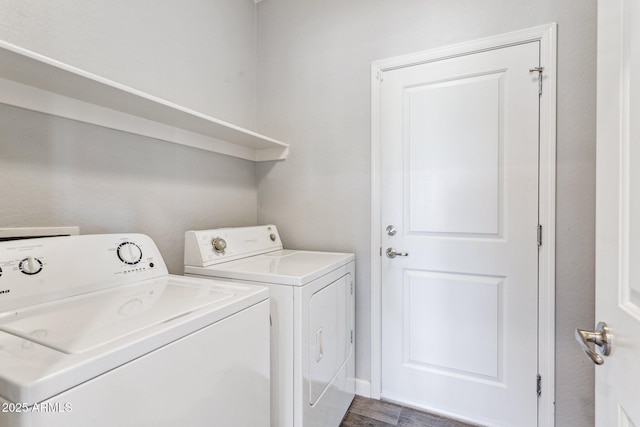 laundry area with dark hardwood / wood-style floors and washing machine and clothes dryer