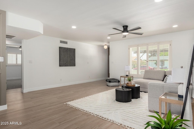 living room featuring ceiling fan, recessed lighting, light wood-style floors, and baseboards