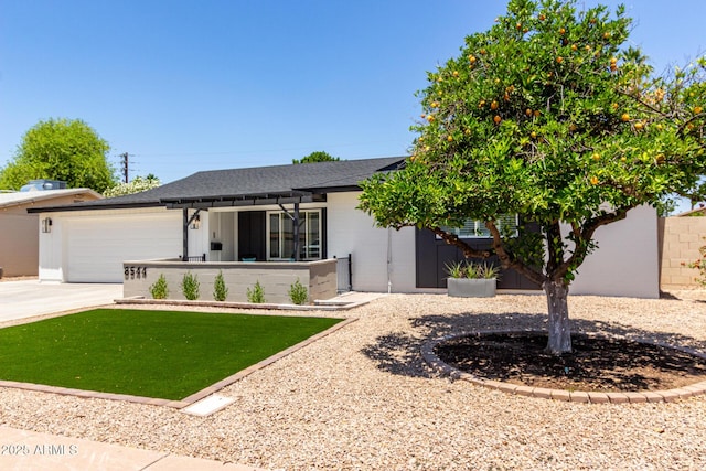 ranch-style home featuring concrete driveway, an attached garage, a shingled roof, and a pergola