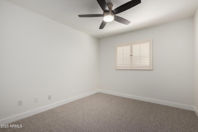 carpeted spare room with baseboards and a ceiling fan