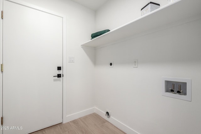 washroom with hookup for a washing machine, hookup for an electric dryer, baseboards, and light wood finished floors