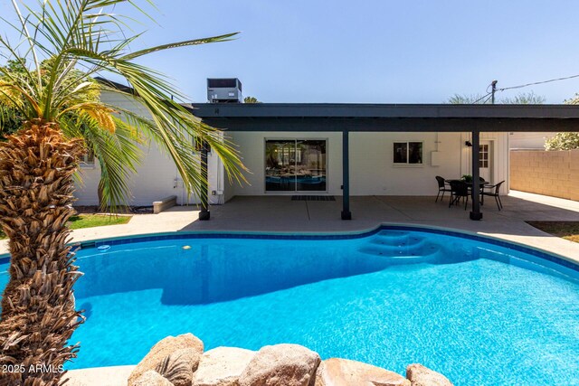swimming pool with central AC unit and a patio area