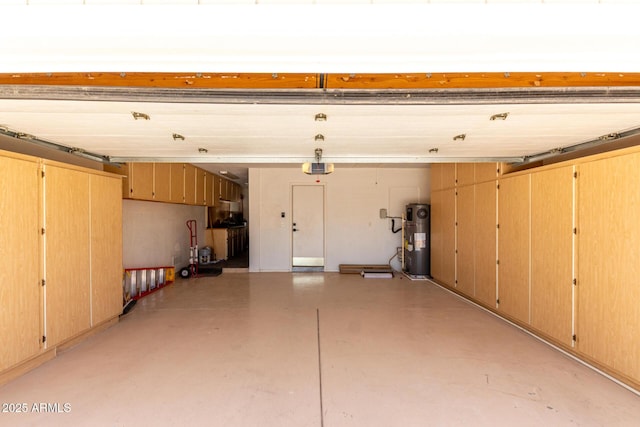 garage featuring water heater and a garage door opener