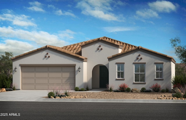 mediterranean / spanish home featuring concrete driveway, an attached garage, a tiled roof, and stucco siding