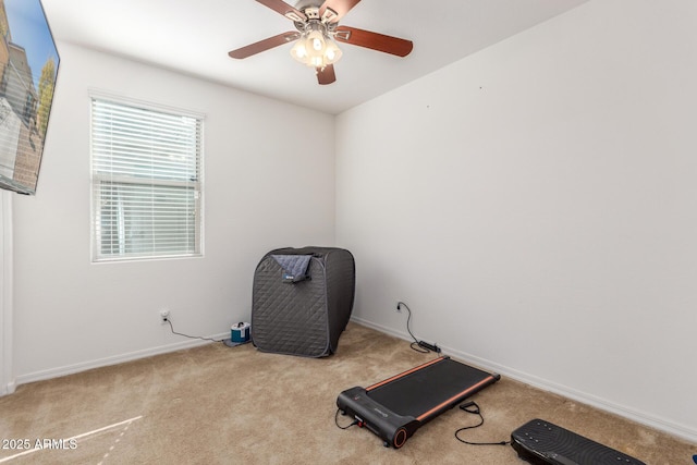 exercise room featuring light carpet and ceiling fan