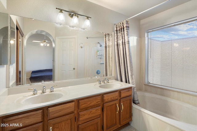 bathroom featuring a sink, a ceiling fan, a bathtub, and double vanity