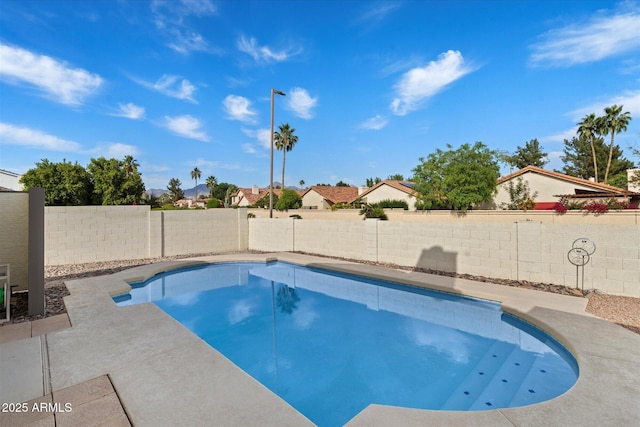 view of swimming pool with a patio, a fenced in pool, and a fenced backyard
