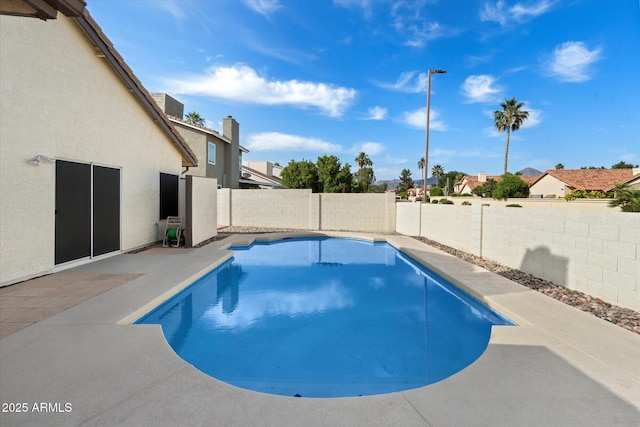 view of swimming pool with a fenced in pool, a fenced backyard, a residential view, and a patio