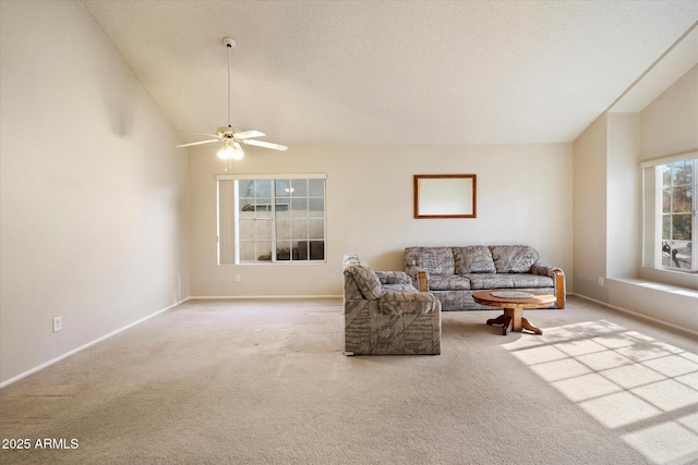 living area with carpet floors, a ceiling fan, and baseboards