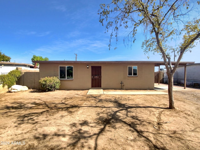 back of house with a patio