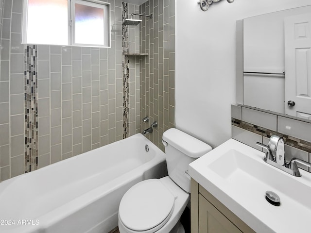 full bathroom featuring vanity, toilet, and tiled shower / bath