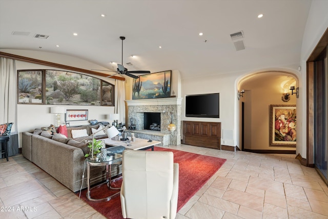 living room featuring lofted ceiling, a fireplace, and ceiling fan