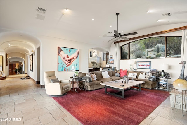 living room with lofted ceiling and ceiling fan