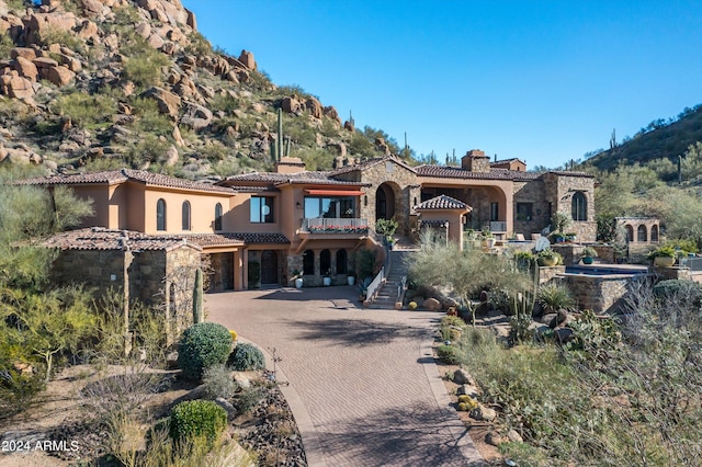 mediterranean / spanish house featuring a mountain view