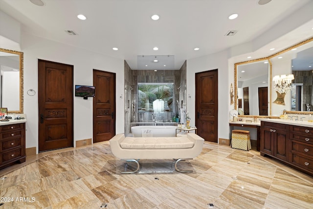 bathroom with a bath, an inviting chandelier, and vanity