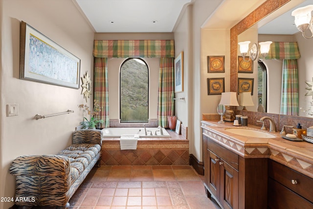 bathroom with vanity, tiled tub, and a notable chandelier